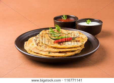 Traditional Indian bread - Aloo paratha or aalu parotha, potato stuffed bread. served with tomato ke