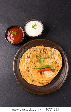 Traditional Indian bread - Aloo paratha or aalu parotha, potato stuffed bread. served with tomato ke