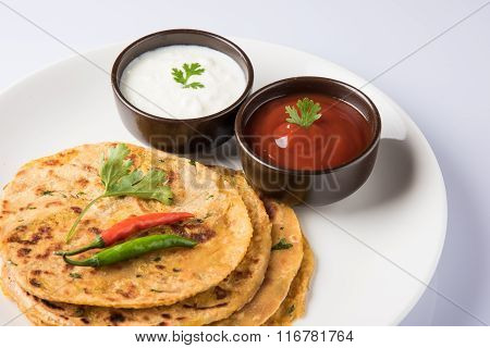 Traditional Indian bread - Aloo paratha or aalu parotha, potato stuffed bread. served with tomato ke