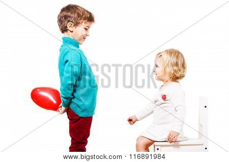 Boy  giving a red balloon to the girl