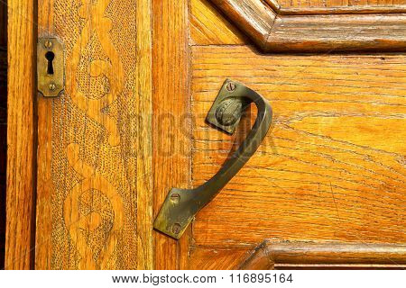 The Travedona Monate Rusty Brass Brown Knocker In A  Door