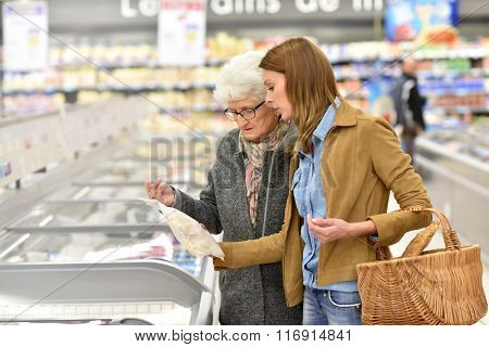 Elderly woman with young woman at the grocery store
