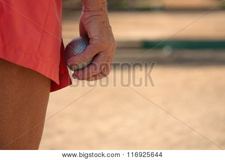 Senior playing petanque