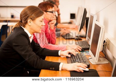 Group Of Adults Learning Computer Skills. Intergenerational Transfer Of Knowledge.
