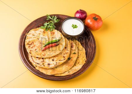 Traditional Indian bread - Aloo paratha or aalu parotha, potato stuffed bread. served with tomato ke