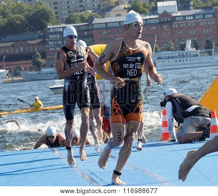 STOCKHOLM - AUG 22 2015: Marco van der Steel and other male swimmers climbing up from the water in the Men's ITU World Triathlon series event August 22 2015 in Stockholm Sweden
