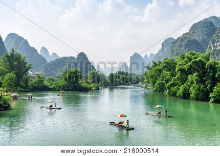 View Of Tourist Bamboo Rafts Sailing Along The Yulong River