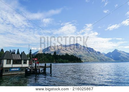 Queentown / New Zealand - 2 December 2017: water observatory office and small ship harbour at lake side in sunny day in autumn