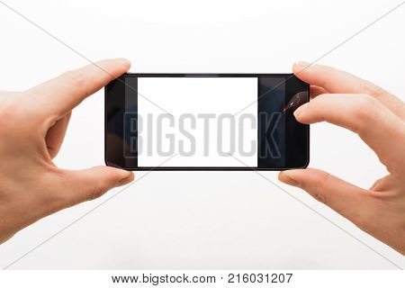 two male hands horizontally holding a smartphone ready to take a picture isolated on white
