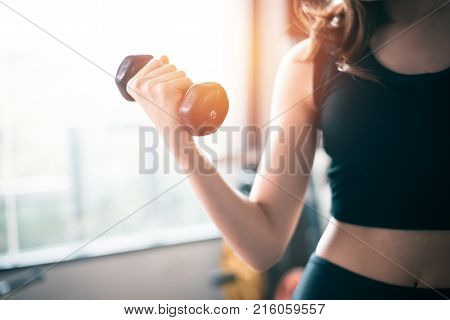 Hand Of Sports Woman Lifting Dumbbell For Weight Training Near Window By Right Hand For Pumping Bice