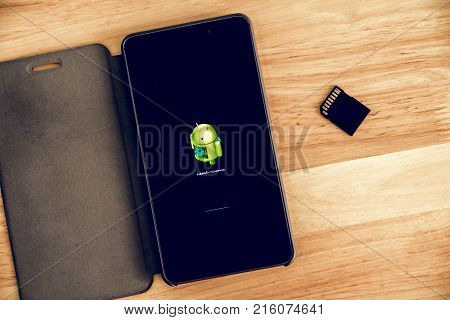 Novemver 30 2017 : Phetchaburi Thailand. A Tablet placed on wood table. The screen showing Andriod updating.