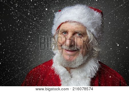 Christmas Santa Claus on dark background with snow