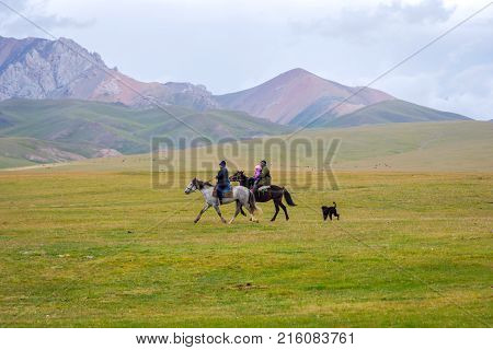 Pair Riding The Horses With A Kid, Kyrgyzstan