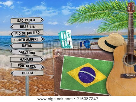 Concept of summer traveling with old suitcase and Brazil town sign