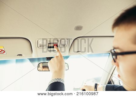 Finger pressing emergency sos button to contact with call center to ask for help after car accident