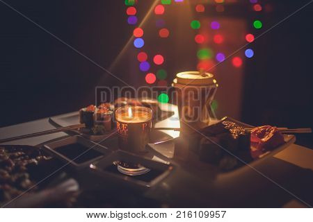 On the table lay the evening land, in the background lit garland