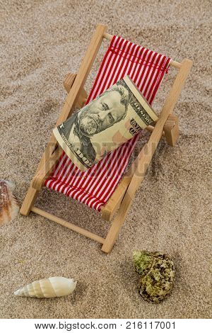 deck chair with piggy bank and dollars