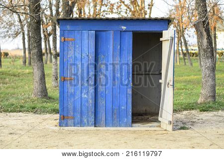 Public Toilet In A Street Park. Blue Wooden Toilet Restroom