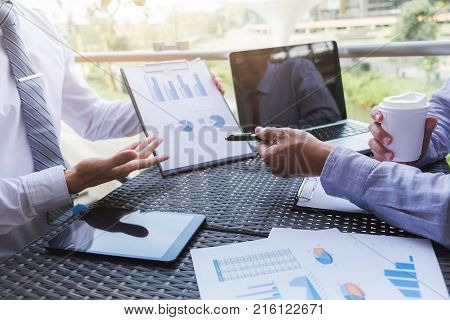 Co working conference Business team meeting present investor executive colleagues discussing new plan financial graph data on outdoors office table with laptop and tablet Finance accounting investment.