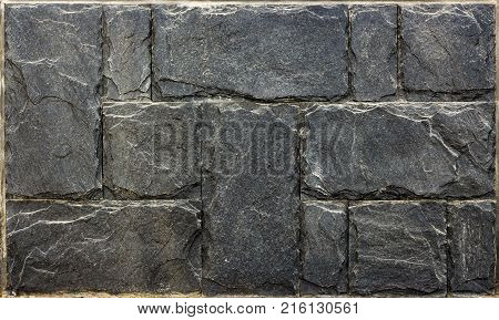 Decorative brick wall from concrete facing tiles as background or texture.