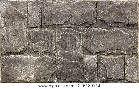 Decorative brick wall from concrete facing tiles as background or texture.