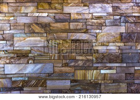 Decorative brick wall from concrete facing tiles as background or texture.