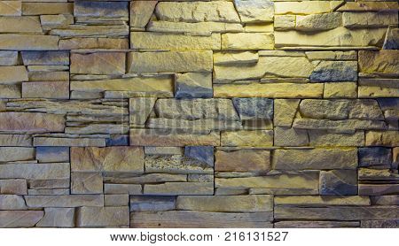 Decorative brick wall from concrete facing tiles as background or texture.
