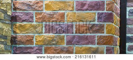 Decorative brick wall from concrete facing tiles as background or texture.