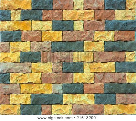 Decorative brick wall from concrete facing tiles as background or texture.