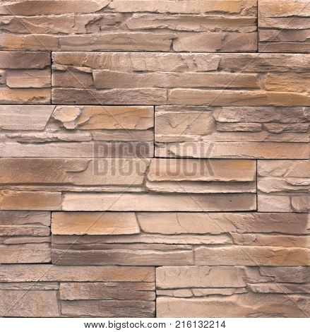 Decorative brick wall from concrete facing tiles as background or texture.