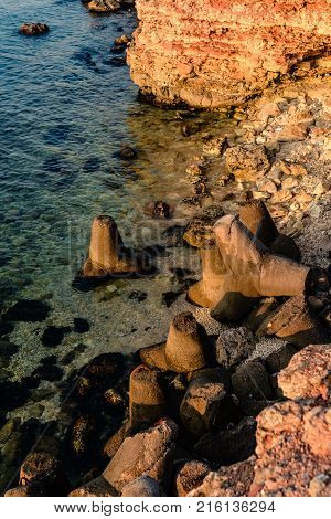 Rocky coast of the sea top view tetrapods