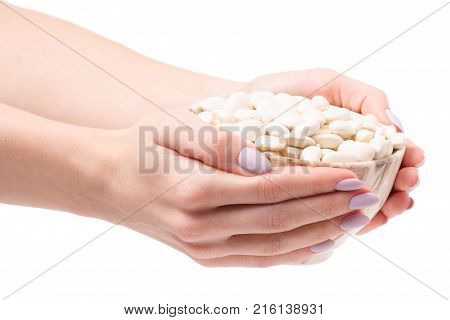White beans in a pial plate of female hands on a white background isolation