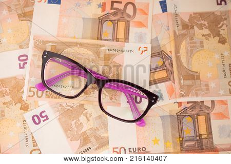 Background with euro money. Magnifier focused on keys. Euro banknotes. 50 euro.