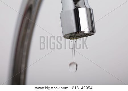 Close-up Of Leakage Tap With Dripping Water Drop