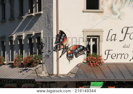 Italy Rocca Pietore - August 26 2016: the view of the decorative ironwork sculpture butterflies on a wall on August 26 2016 Veneto Italy.
