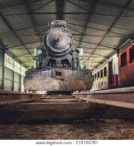 Front View of an Old Steam Locomotive Standing in the Depo
