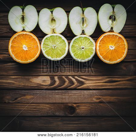 Bright and juicy apples oranges and lemons. Citrus fruit.
