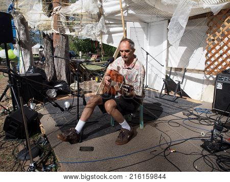Oahu - February 20 2017: Man Playing Guitar On Stage At Optimysstique 2017 Campout Under A Giant Sai