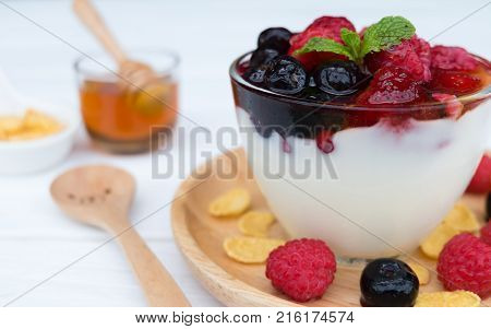 Yogurt, fruit and strawberry, raspberry, blueberry on old wood floor
