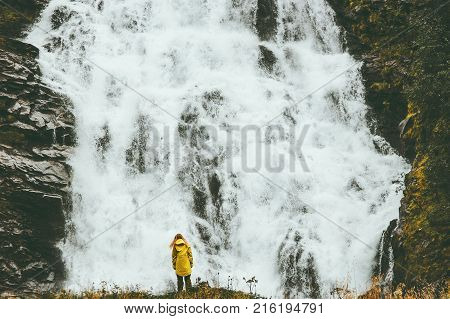 Woman enjoying big waterfall landscape view outdoor Travel Lifestyle concept adventure scandinavian vacations in Norway