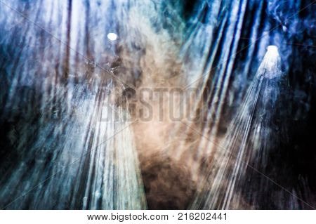 Theatrical smoke on stage. Lighting equipment. Theatrical performance or show.