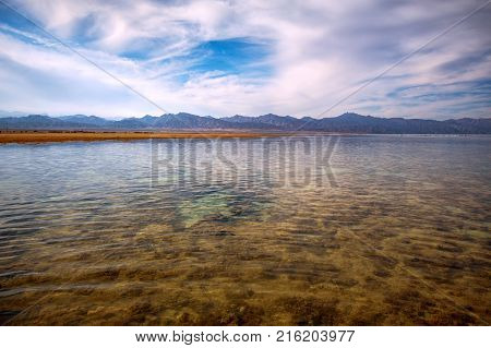 Low tide in the Nabq national park. Mountains on the horizon at sunset.