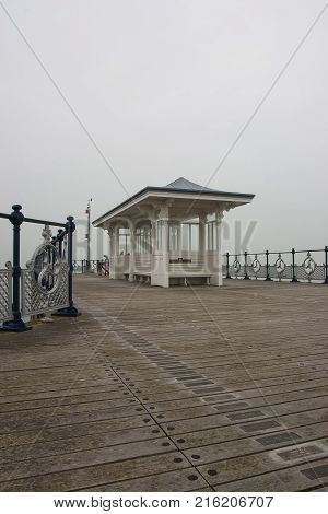 Swanage Pier in the mist Dorset England. It is a pier in the coastal town of Swanage built in 1895 for passenger services.