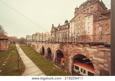 NUREMBERG, GERMANY - NOVEMBER 15, 2017: Train moving under the bridge in historical Bavarian city with fort walls on November 15, 2017. Nurnberg is second-largest city in Bavaria popul. 763854.