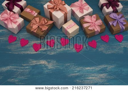 Valentine's day background with Decorative composition garland on painted wood background. Top view Flat lay