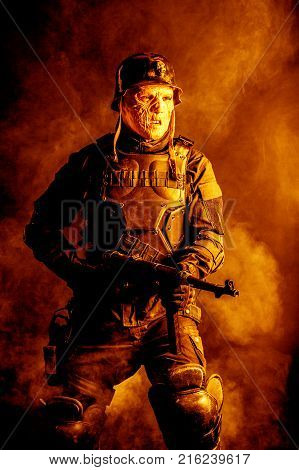 Ugly face of Futuristic nazi soldier in gas mask and steel helmet. Skin burned by atomic flame