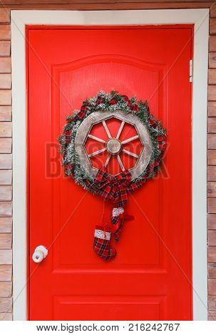Christmas wreath with fir cones on red background.