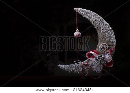 Christmas card. Christmas background with a month Christmas tree toy with a cone on a black background