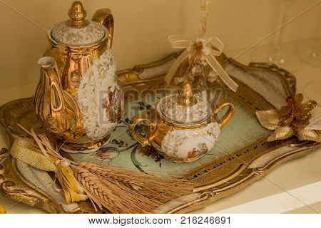 antique tea service decorated in gold with background