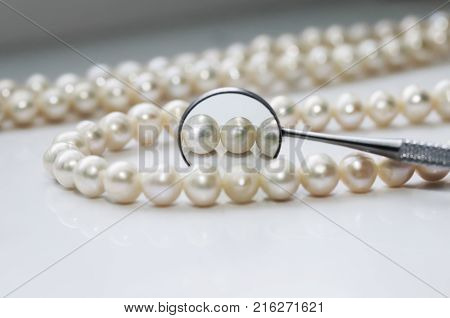 dazzling pearls and are reflected in a dental mirror
